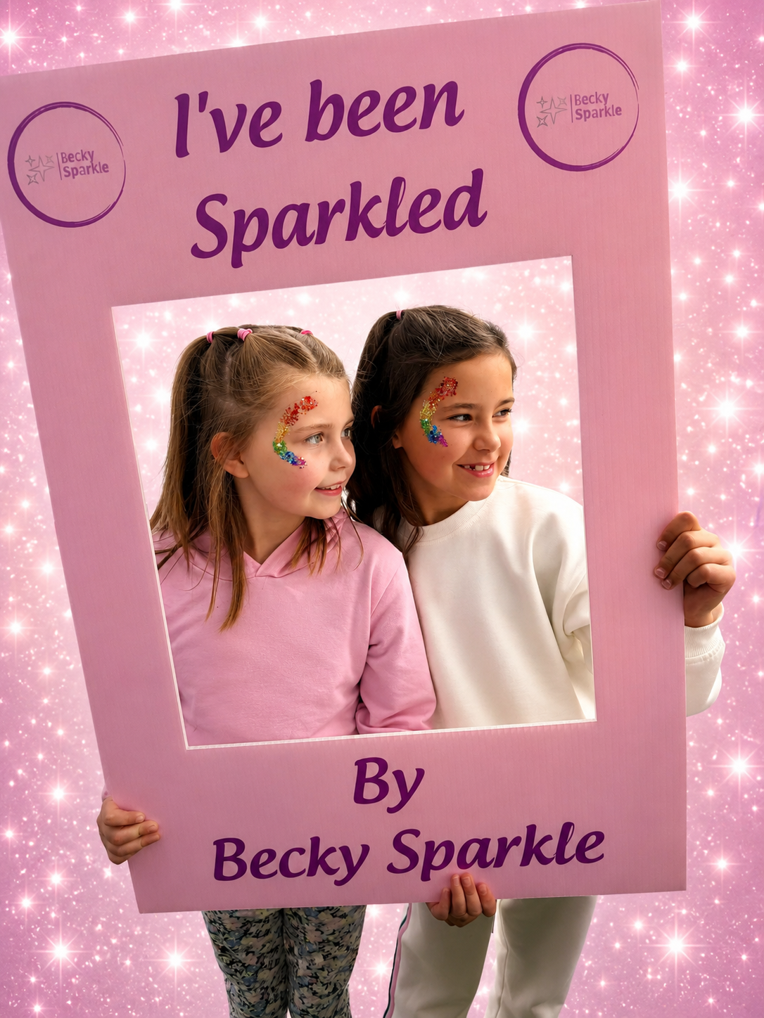 Girls holding I've Been Sparkled sign
